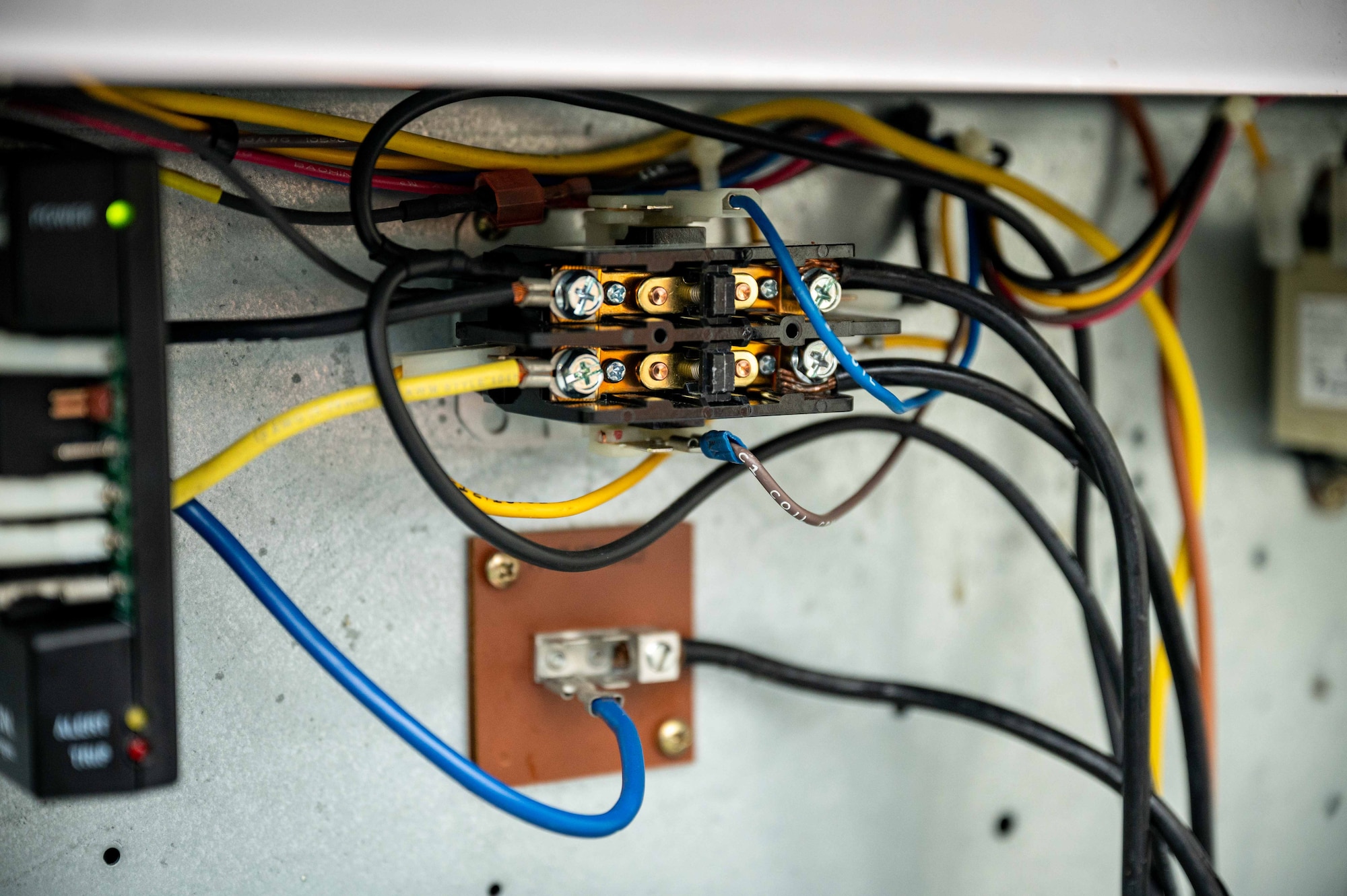 A close-up photo of a terminal block in a condenser unit.