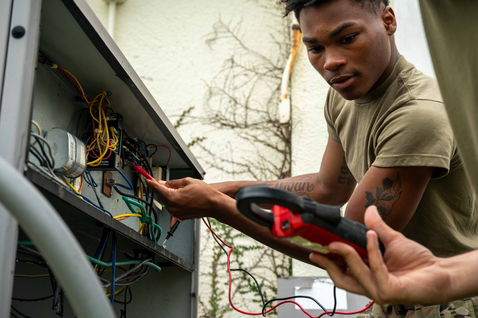An Airman conducts a test on a condenser.