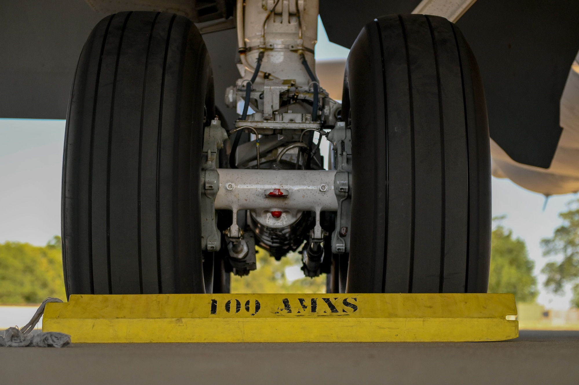 Chocks are placed in front of the landing gear of a U.S. Air Force KC-135 Stratotanker assigned to the 100th Air Refueling Wing, on the flightline at RAF Mildenhall, England, July 11, 2025.