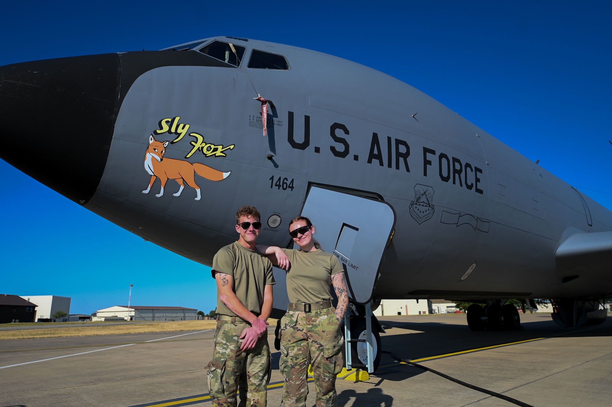 U.S. Air Force Airman 1st Class Connor Habusta , left and Airman 1st Class Kayla Arnold, 100th Aircraft Maintenance Squadron crew chiefs, pose in front of a U.S. Air Force KC-135 Stratotanker at RAF Mildenhall, England, July 11, 2025.