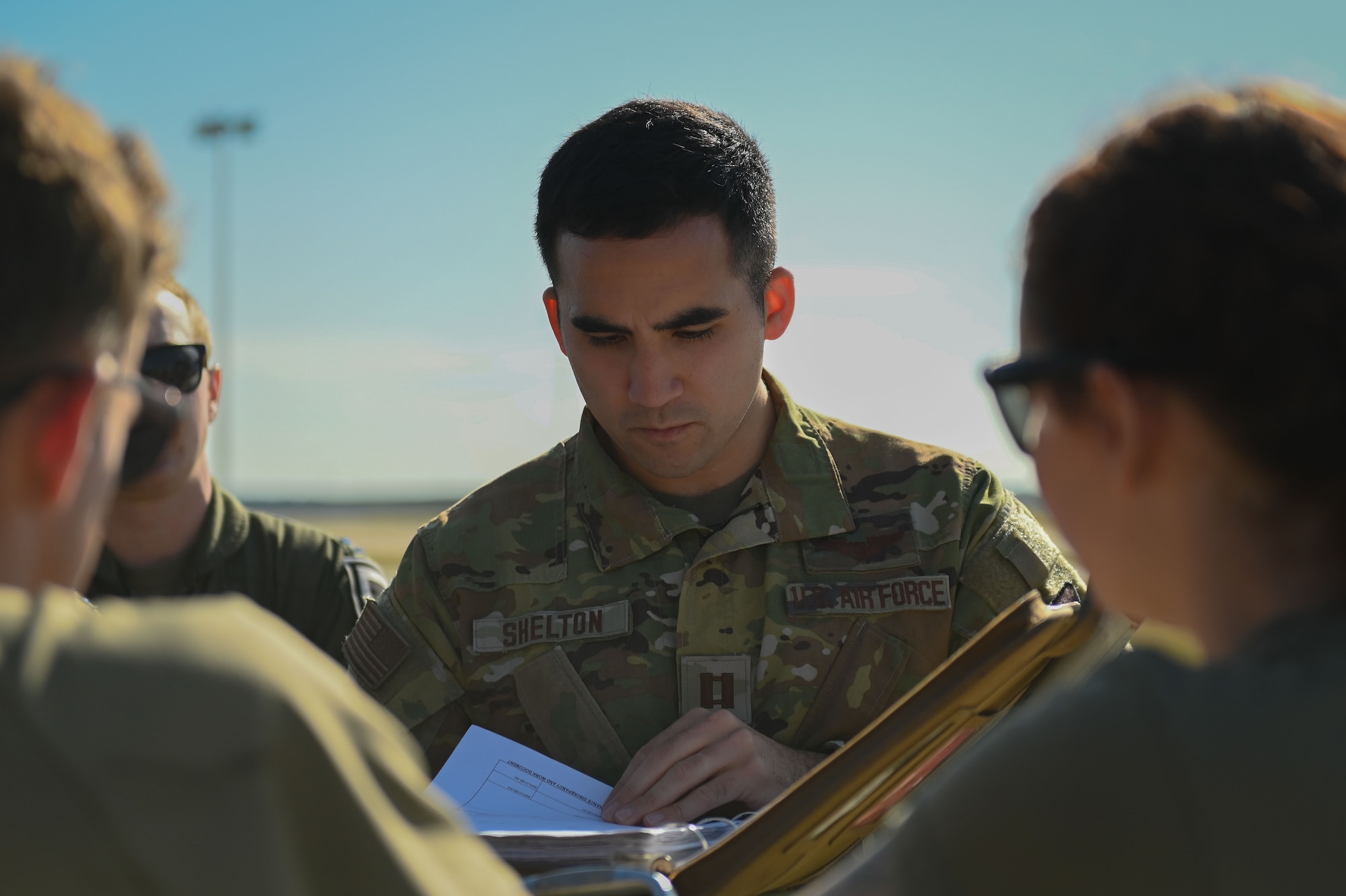 U.S. Air Force Capt. Alexander Shelton, 351st Air Refueling Squadron KC-135 Stratotanker pilot, reads the maintenance forms before a refueling mission at RAF Mildenhall, England, July 11, 2025.