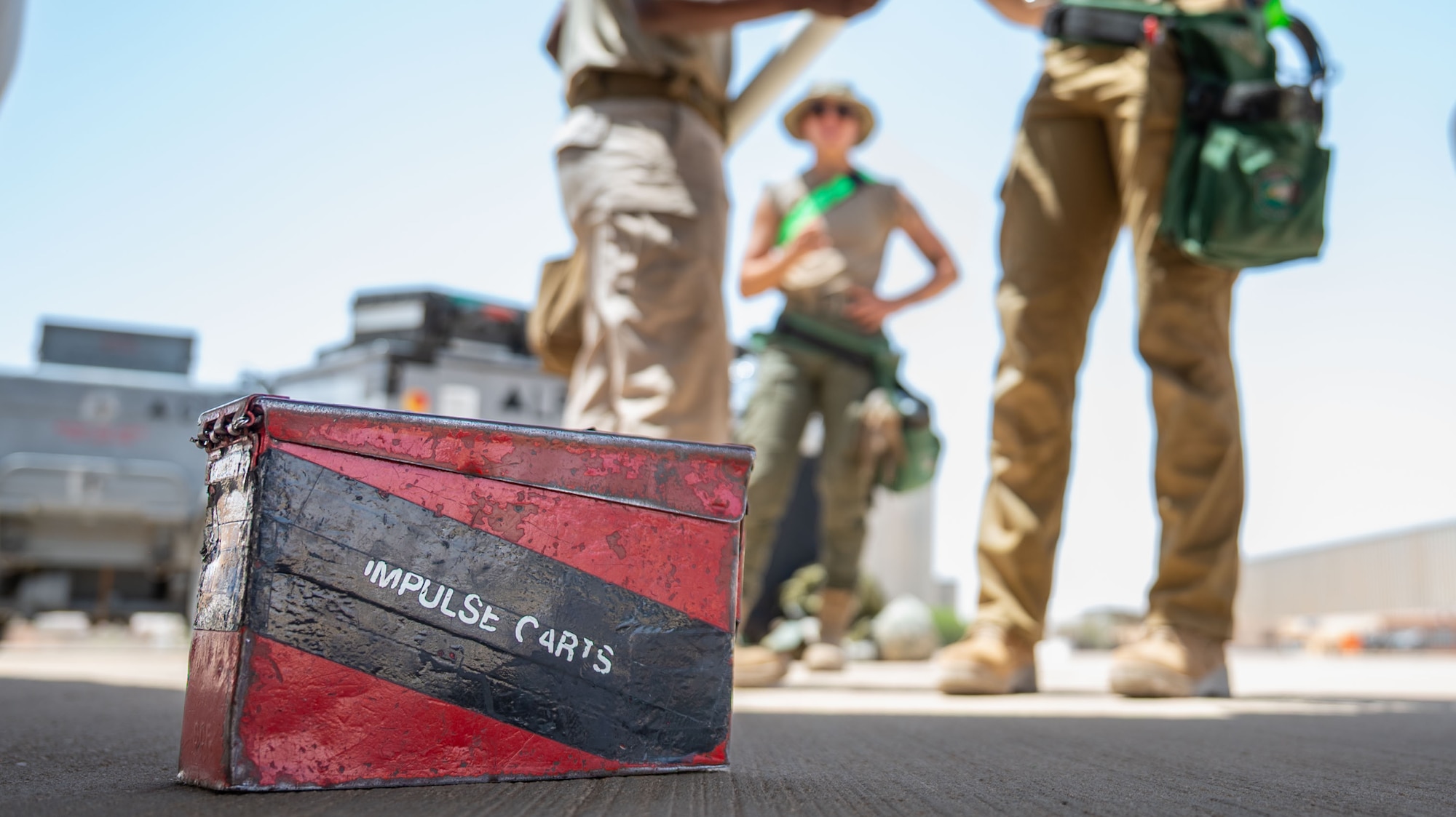 An impulse cartridge box sits on an airfield.