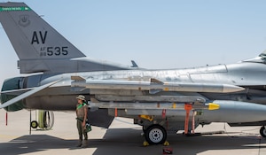 An Airman stands by an F-16 Fighting Falcon.