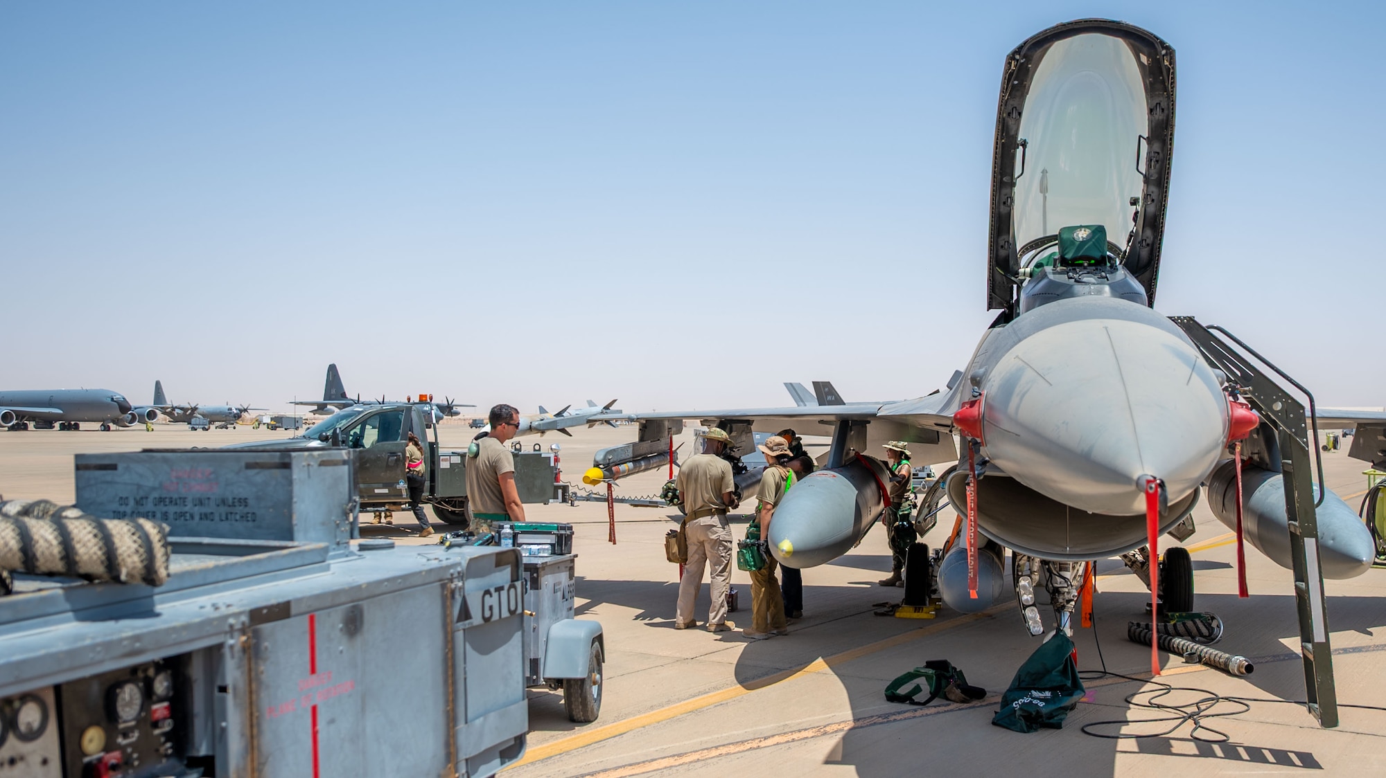 U.S. Airmen assigned to the 555th Expeditionary Fighter Generation Squadron load Advanced Precision Kill Weapon System rockets onto an F-16C Fighting Falcon