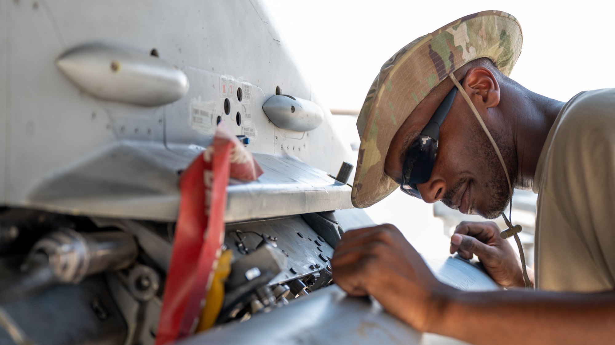 An Airman inspects a Triple Ejector Rack-9/A .