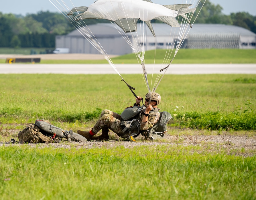 A soldier from the 412th Civil Affairs Battalion successfully lands after jumping from a KC-130 Aircraft during an exercise at Wright-Patterson Air Force Base, Ohio, Aug. 2, 2025.  Based in Columbus, Ohio, the 412th is a U.S. Army Reserve unit that regularly conducts parachute training exercises and airborne operations. (U.S. Air Force photo by Jack Gardner)