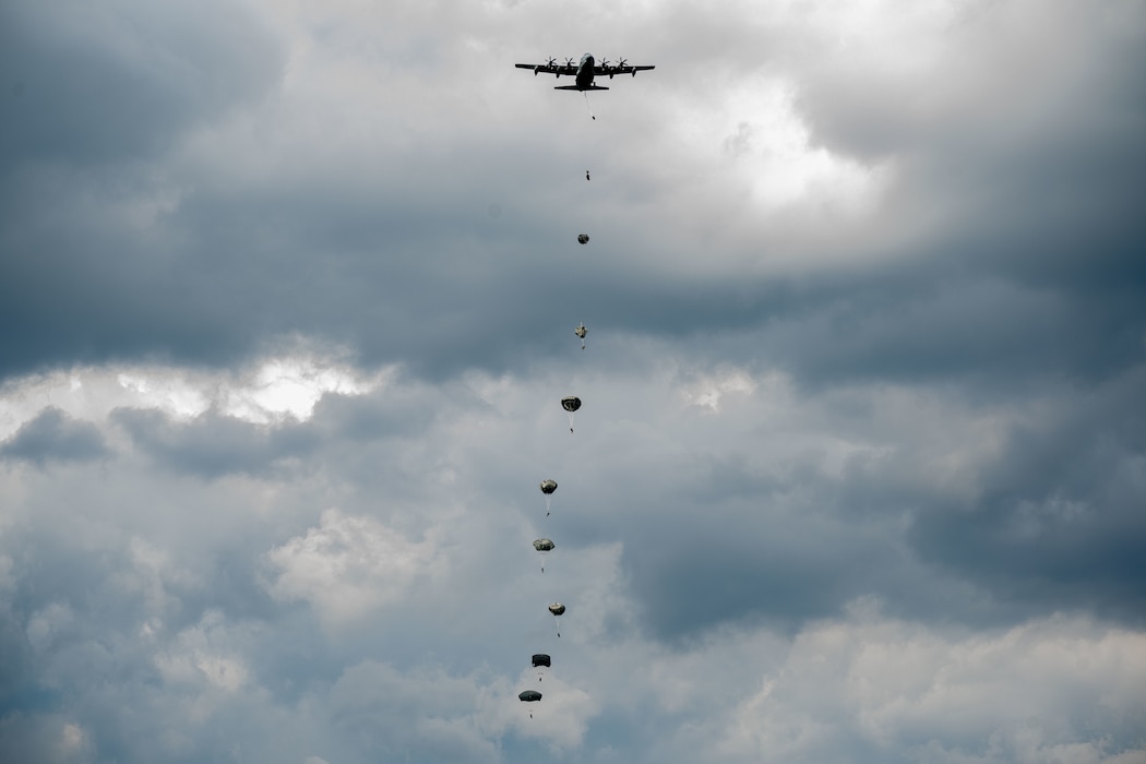 Soldiers of the 412th Civil Affairs Battalion jump from a KC-130 Aircraft during an exercise at Wright-Patterson Air Force Base, Ohio, Aug. 2, 2025.  Based in Columbus, Ohio, the 412th is a U.S. Army Reserve unit that regularly conducts parachute training exercises and airborne operations. (U.S. Air Force photo by Jack Gardner)