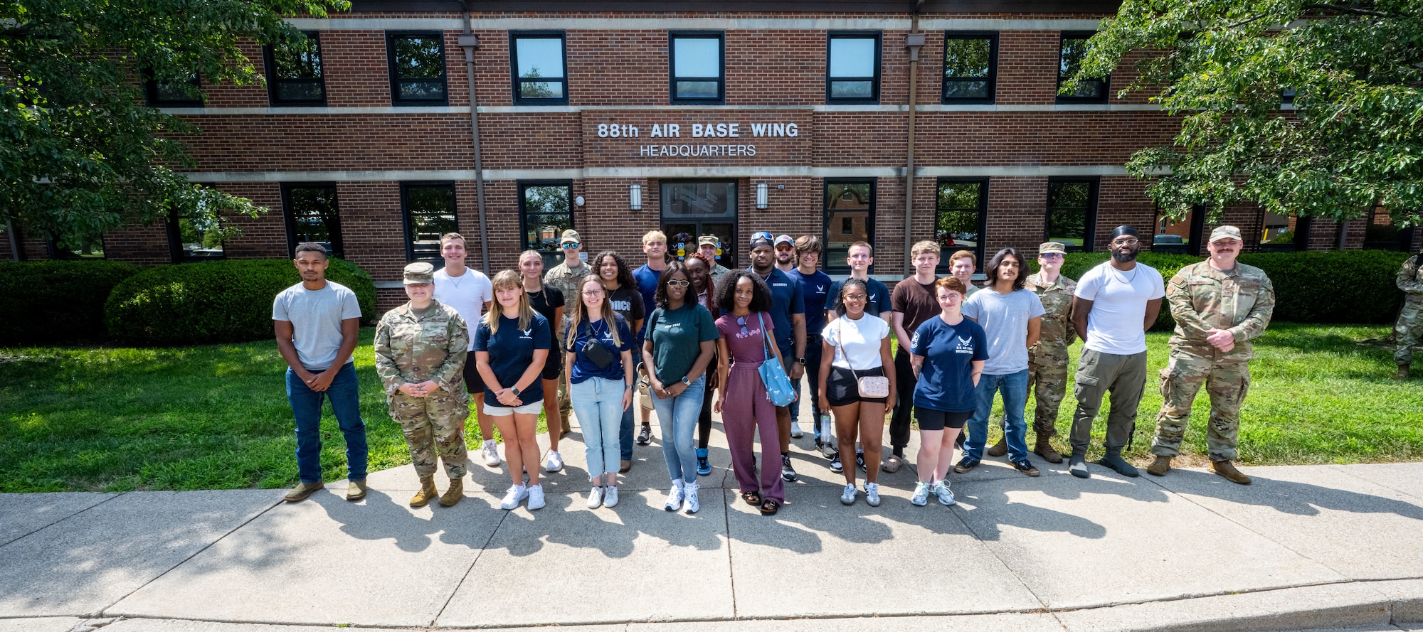 Air Force and Space Force recruits in the Delayed Entry Program pose for a group photo in front of the 88th Air Base Wing Headquarters building at Wright-Patterson Air Force Base, Ohio, July 30, 2025. The recruits are with the 338th Recruiting Squadron, which covers Ohio, Indiana, Kentucky and West Virginia. (U.S. Air Force photo by Jack Gardner)
