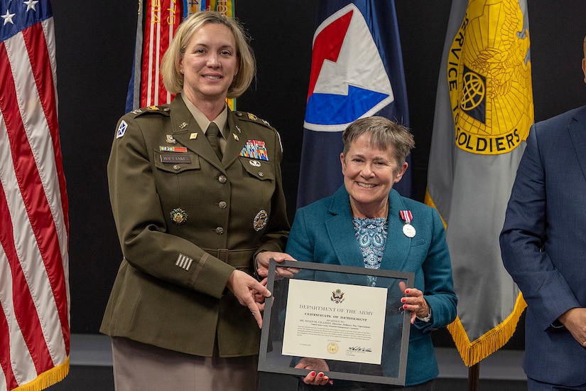 Col. Michelle M. Williams, U.S. Army Financial Management Command commander, presents Susan Gillison, USAFMCOM Military Pay Operations director, with a certificate of retirement during Gillison’s retirement ceremony at the Maj. Gen. Emmett J. Bean Federal Center in Indianapolis Oct. 28, 2024. Gillison, a Mercer, Pennsylvania native, is an Army veteran whose service to the nation spans 41 years with more than 2 years in the U.S. Army Reserve, more than 21 years in the Regular Army, and more than 17 years of government civilian service with the Defense Finance and Accounting Service and USAFMCOM. (U.S. Army photo by Mark R. W. Orders-Woempner)