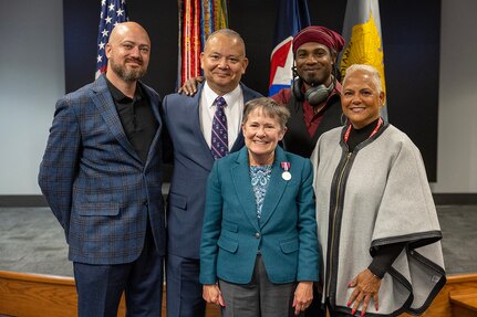Susan Gillison, U.S. Army Financial Management Command Military Pay Operations director, poses for a photo with her family during her retirement ceremony at the Maj. Gen. Emmett J. Bean Federal Center in Indianapolis Oct. 28, 2024. Gillison, a Mercer, Pennsylvania native, is an Army veteran whose service to the nation spans 41 years with more than 2 years in the U.S. Army Reserve, more than 21 years in the Regular Army, and more than 17 years of government civilian service with the Defense Finance and Accounting Service and USAFMCOM. (U.S. Army photo by Mark R. W. Orders-Woempner)