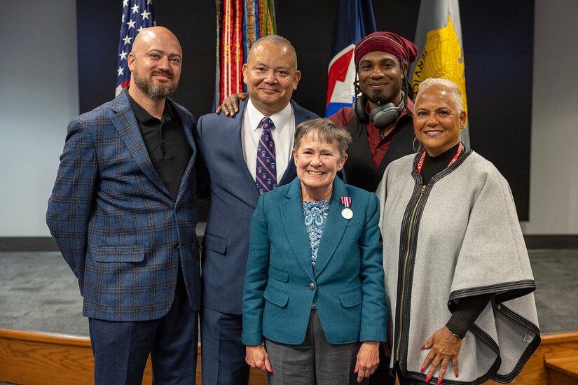 Susan Gillison, U.S. Army Financial Management Command Military Pay Operations director, poses for a photo with her family during her retirement ceremony at the Maj. Gen. Emmett J. Bean Federal Center in Indianapolis Oct. 28, 2024. Gillison, a Mercer, Pennsylvania native, is an Army veteran whose service to the nation spans 41 years with more than 2 years in the U.S. Army Reserve, more than 21 years in the Regular Army, and more than 17 years of government civilian service with the Defense Finance and Accounting Service and USAFMCOM. (U.S. Army photo by Mark R. W. Orders-Woempner)