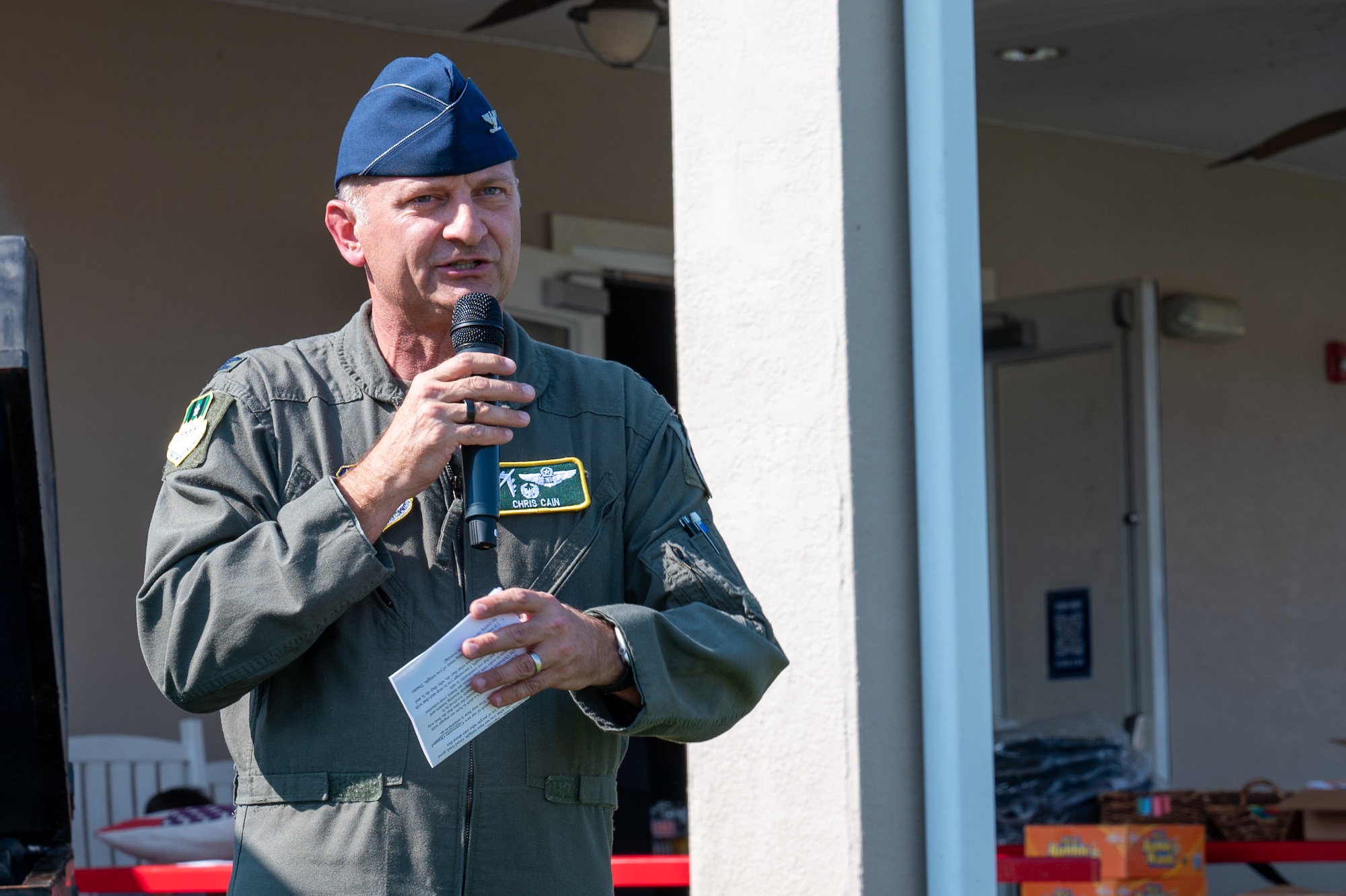 U.S. Air Force Col. Chris G. Cain, 2nd Bomb Wing commander, gives opening remarks for National Night Out