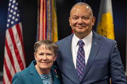 Susan Gillison, U.S. Army Financial Management Command Military Pay Operations director, poses for a photo with her husband, Aaron Gillison, during her retirement ceremony at the Maj. Gen. Emmett J. Bean Federal Center in Indianapolis Oct. 28, 2024. Gillison, a Mercer, Pennsylvania native, is an Army veteran whose service to the nation spans 41 years with more than 2 years in the U.S. Army Reserve, more than 21 years in the Regular Army, and more than 17 years of government civilian service with the Defense Finance and Accounting Service and USAFMCOM. (U.S. Army photo by Mark R. W. Orders-Woempner)