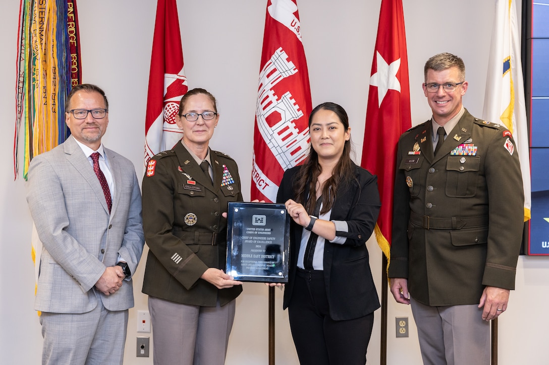 A group pose with the 2024 chief of engineers safety award of excellence