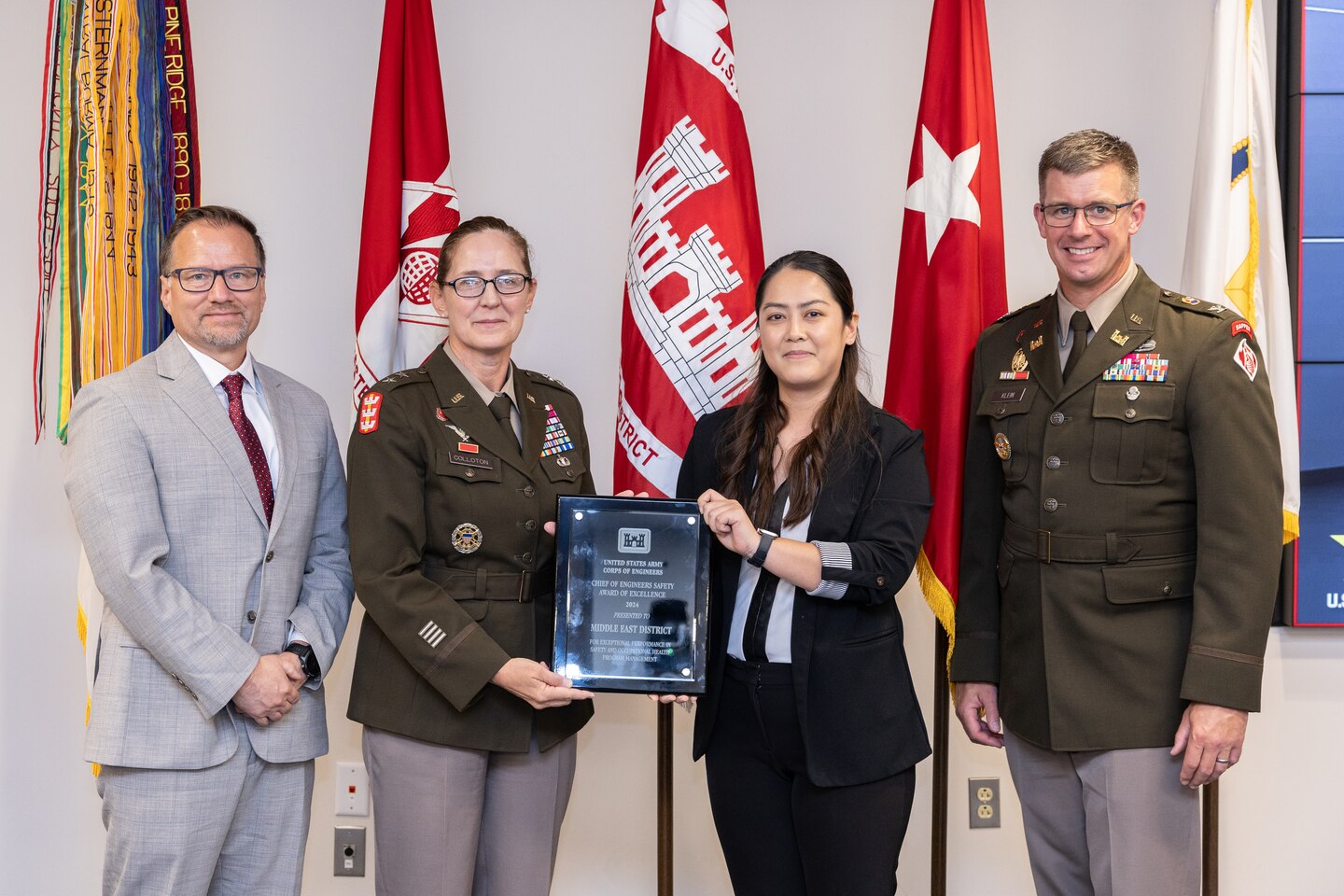 A group pose with the 2024 chief of engineers safety award of excellence
