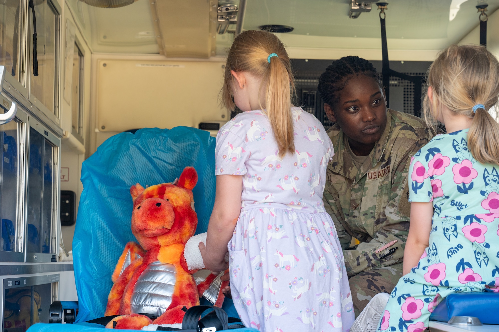 U.S. Air Force Airman 1st Class Daveika Hall, 2nd Medical Group medic, teaches children how to perform first aid