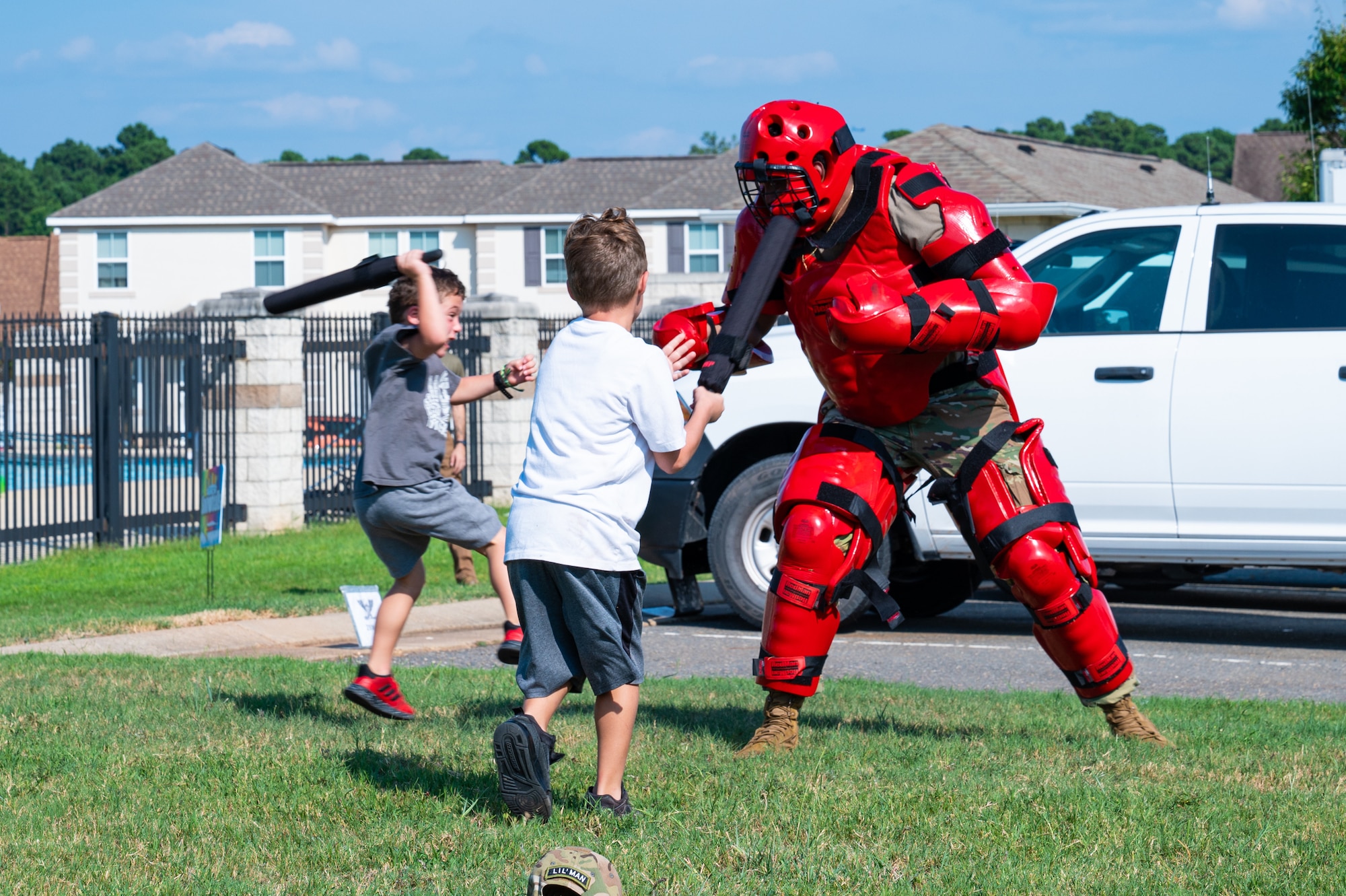 U.S. Air Force Airman Janorris Sejour, 2nd Security Forces Squadron patrolman, wears the red man training suit to teach children about defensive tactics training