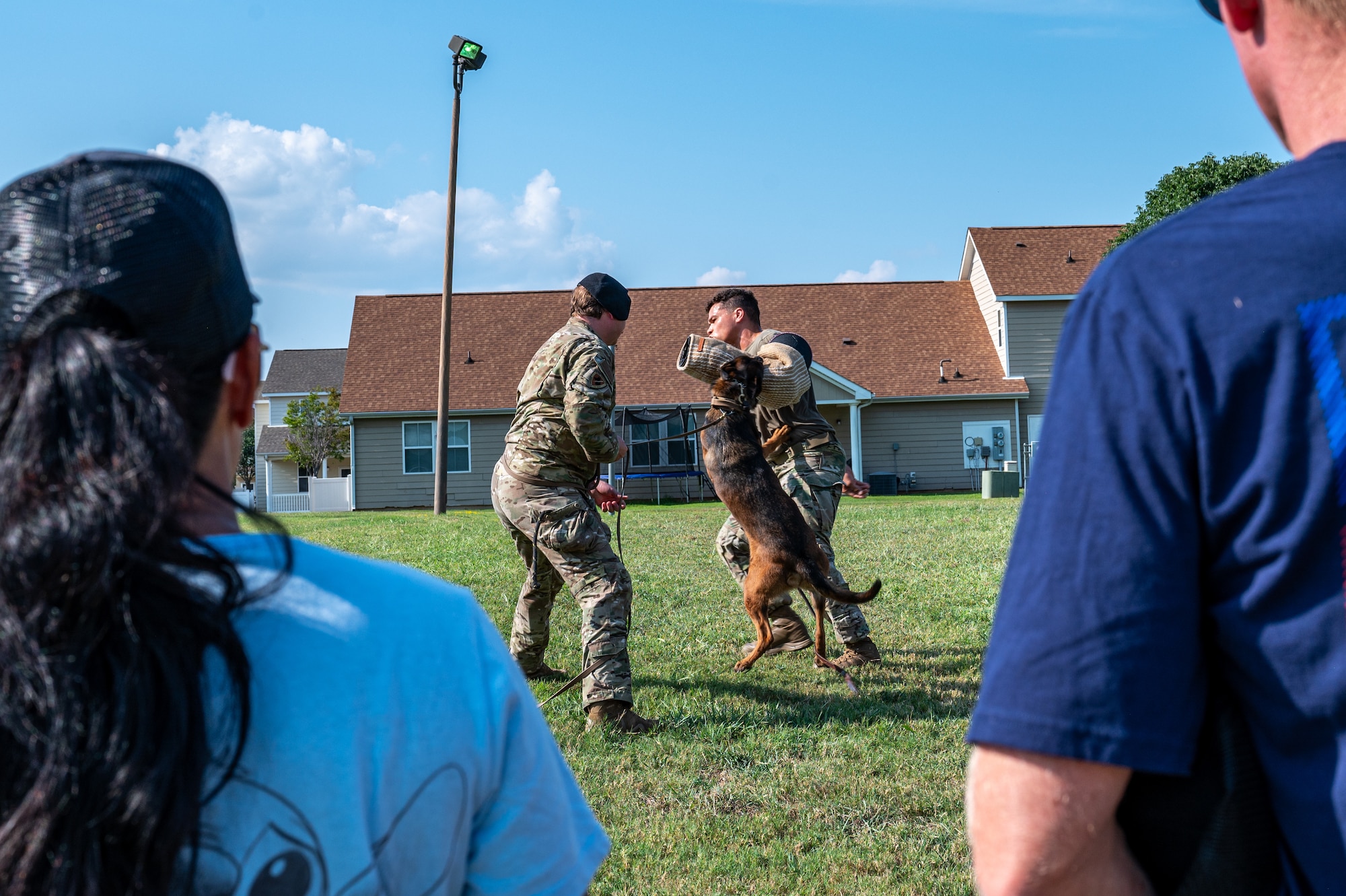 U.S. Air Force Staff Sgt. Cody Wilson, 2nd Security Forces Squadron military working dog handler and Staff Sgt. Brandon Calwile, 2nd SFS MWD trainer, perform a controlled aggression demonstration