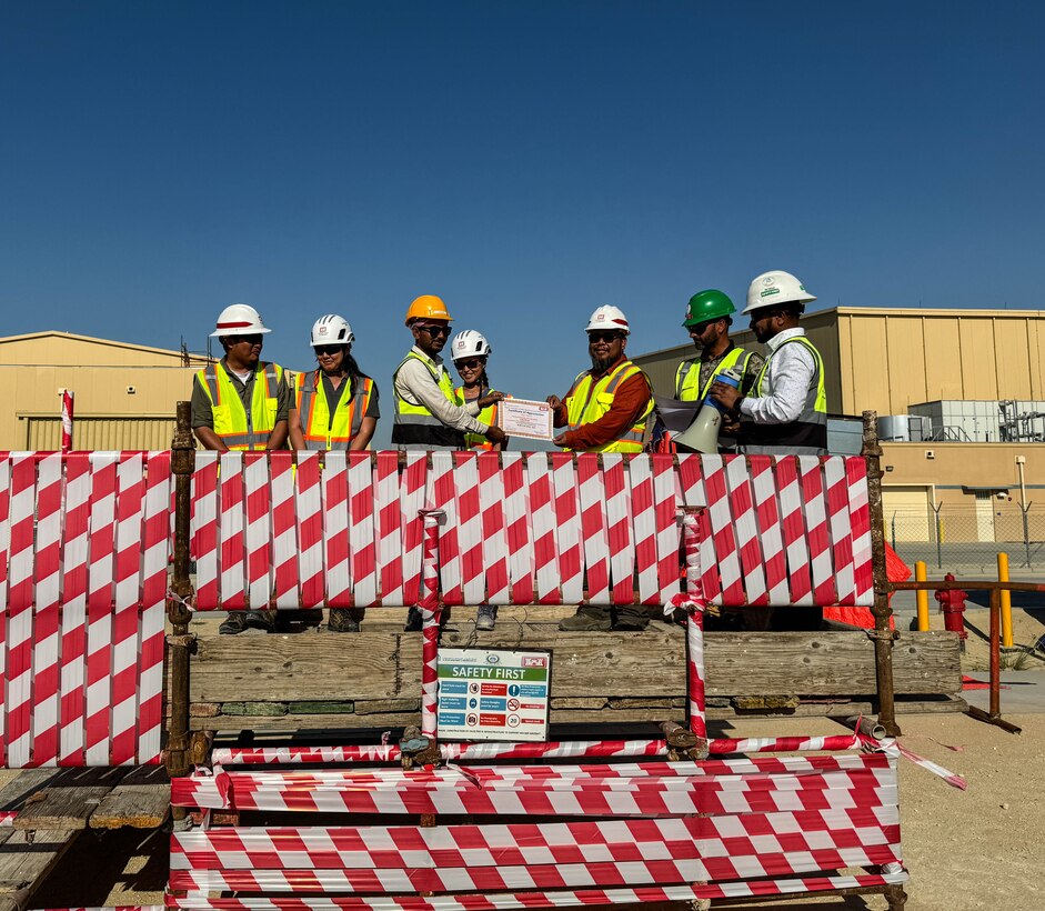 An award is presented to a person on a makeshift stage.