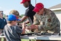 U.S. Air Force Senior Airman Richard Stiller, 2nd Security Forces Squadron combat arms training and maintenance instructor, demonstrates how to disassemble a weapon