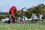 U.S. Air Force Airman Janorris Sejour, 2nd Security Forces Squadron patrolman, wears the red man training suit to teach children about defensive tactics training