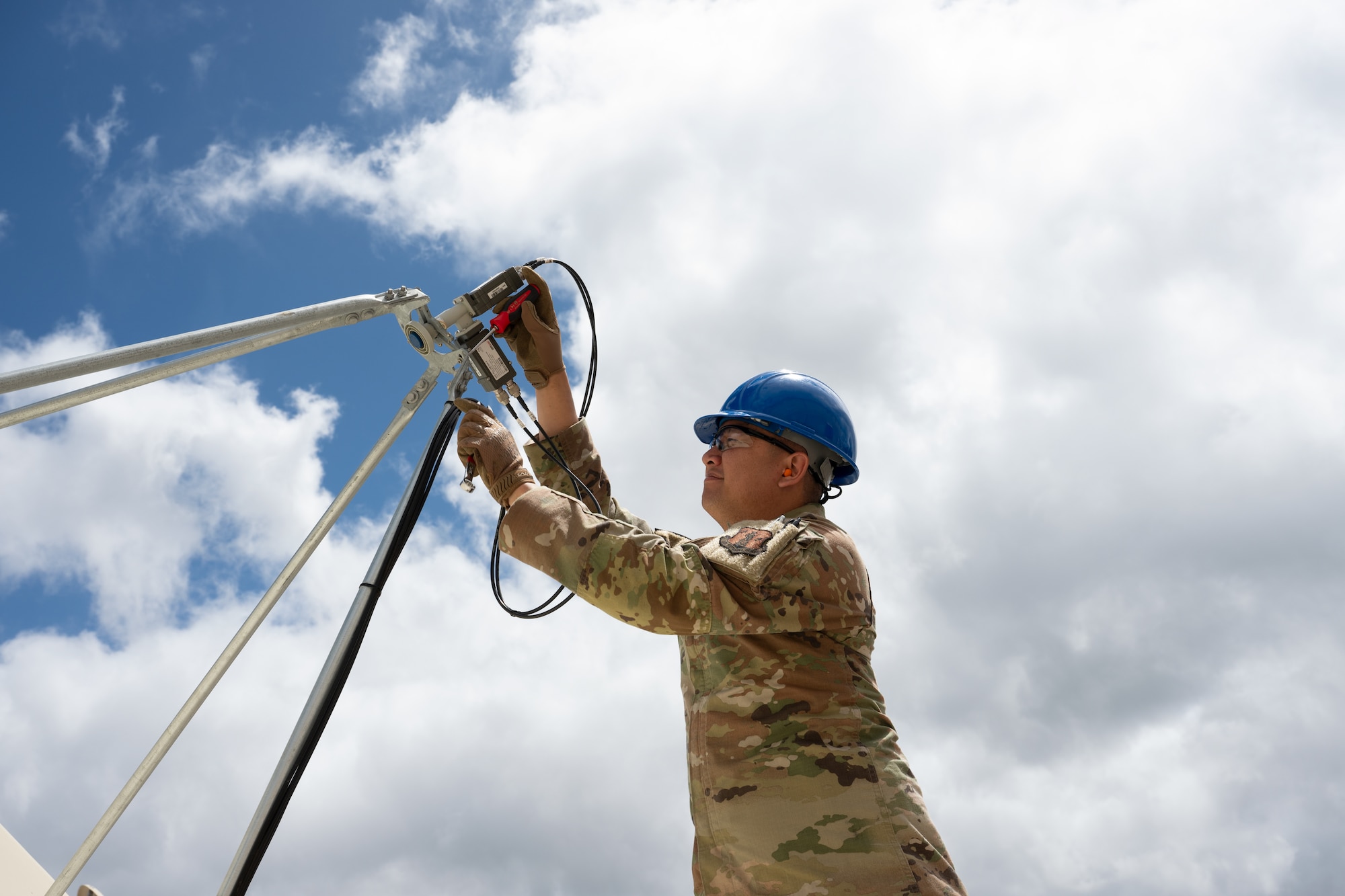 Air Force Senior Airman Mike Herreros, 109th Electromagnetic Warfare Squadron, Hawaii Air National Guard, inspects antenna equipment at Joint Base Pearl Harbor-Hickam, Hawaii, at the start of Resolute Space, July 8, 2025. Nested under the 2025 Department of the Air Force exercise series, Resolute Space 2025 demonstrates the Space Force’s preparedness for complex, large-scale military operations by exercising its ability to operate in a contested, dynamic environment against high-end threats on short notice across the service and with joint and international partners.