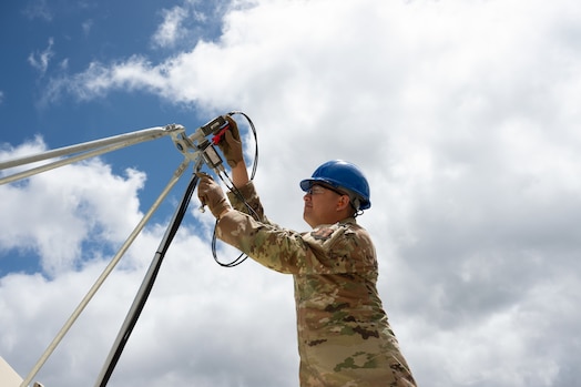  Air Force Senior Airman Mike Herreros, 109th Electromagnetic Warfare Squadron, Hawaii Air National Guard, inspects antenna equipment at Joint Base Pearl Harbor-Hickam, Hawaii, at the start of Resolute Space, July 8, 2025. Nested under the 2025 Department of the Air Force exercise series, Resolute Space 2025 demonstrates the Space Force’s preparedness for complex, large-scale military operations by exercising its ability to operate in a contested, dynamic environment against high-end threats on short notice across the service and with joint and international partners.
