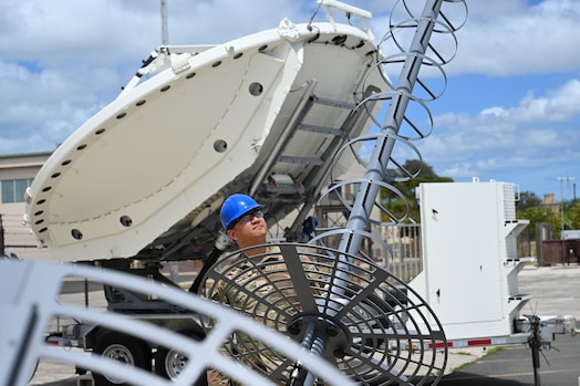  Air Force Senior Airman Mike Herreros, 109th Electromagnetic Warfare Squadron, Hawaii Air National Guard, inspects antenna equipment at Joint Base Pearl Harbor-Hickam, Hawaii, at the start of Resolute Space, July 8, 2025. Nested under the 2025 Department of the Air Force exercise series, Resolute Space 2025 demonstrates the Space Force’s preparedness for complex, large-scale military operations by exercising its ability to operate in a contested, dynamic environment against high-end threats on short notice across the service and with joint and international partners. (U.S. Space Force photo by Lt. Col. Victoria Hight)