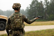 U.S. Army Spc. Ian Anglin, assigned to the Deathwatch Platoon, 10th Brigade Engineer Battalion, 1st Armored Brigade Combat Team, 3rd Infantry Division, assisting during a first person view drone release, on Grafenwöhr Training Area, July 21, 2025. The 1 ABCT, 3rd Infantry Division, tests purpose-built, retrievable FPV drones to highlight the ability against autonomous targets to improve battlefield readiness and integration with armored units. The 3rd Infantry Division and V Corps are part of America’s Forward Deployed Corps in Europe which works alongside NATO Allies and regional security partners to provide combat-ready forces, execute joint and multinational training exercises, and retain command and assigned units in the European Theater. (U.S. Army photo by Spc. Josefina Garcia)