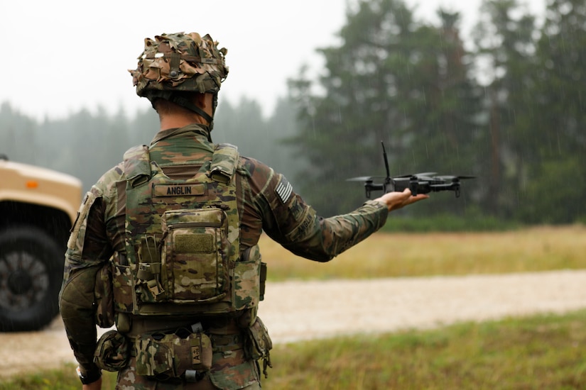 U.S. Army Spc. Ian Anglin, assigned to the Deathwatch Platoon, 10th Brigade Engineer Battalion, 1st Armored Brigade Combat Team, 3rd Infantry Division, assisting during a first person view drone release, on Grafenwöhr Training Area, July 21, 2025. The 1 ABCT, 3rd Infantry Division, tests purpose-built, retrievable FPV drones to highlight the ability against autonomous targets to improve battlefield readiness and integration with armored units. The 3rd Infantry Division and V Corps are part of America’s Forward Deployed Corps in Europe which works alongside NATO Allies and regional security partners to provide combat-ready forces, execute joint and multinational training exercises, and retain command and assigned units in the European Theater. (U.S. Army photo by Spc. Josefina Garcia)