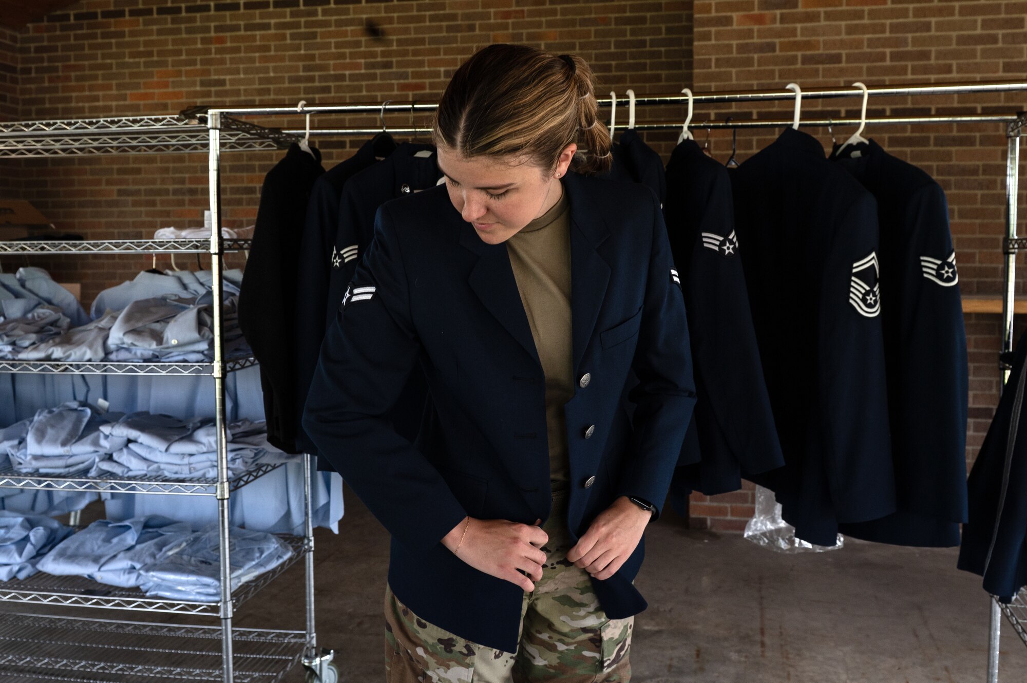 U.S. Air Force Airman 1st Class Cailey Aandal, 133rd Public Affairs, tries on clothes during a blues swap in St. Paul, Minn., June 7, 2025.