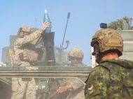 U.S. Air Force Senior Airmen Reese Riccardo, a tactical air control party serving as the joint terminal attack controller assigned to 15th Air Support Operation Squadron, supporting 5th Squadron, 7th Cavalry Regiment, Fire Support Team, 1st Battalion, 41st Field Artillery, 1st Armored Brigade Combat Team, 3rd Infantry Division, fires a mortar round during a Combined Arms Live Fire Exercise (CALFEX) July 25, 2025, at the Central Training Area near Camp Tapa, Estonia. This CALFEX served as a way to increase lethality and effectiveness, and improve the interoperability between NATO allies and partners. (U.S. Army photo by Spc. Nathan Morse)