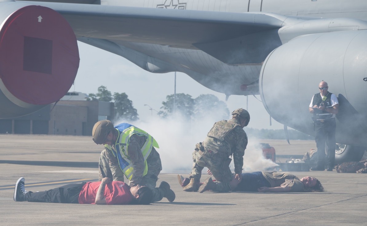 U.S. Air Force personnel with the 316th Security Forces Group assess injured role players during a field training exercise at Joint Base Andrews, Md., July 24, 2025. Multiple units rehearsed rapid emergency response techniques in preparation for large-scale events.