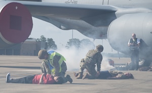U.S. Air Force personnel with the 316th Security Forces Group assess injured role players during a field training exercise at Joint Base Andrews, Md., July 24, 2025. Multiple units rehearsed rapid emergency response techniques in preparation for large-scale events.