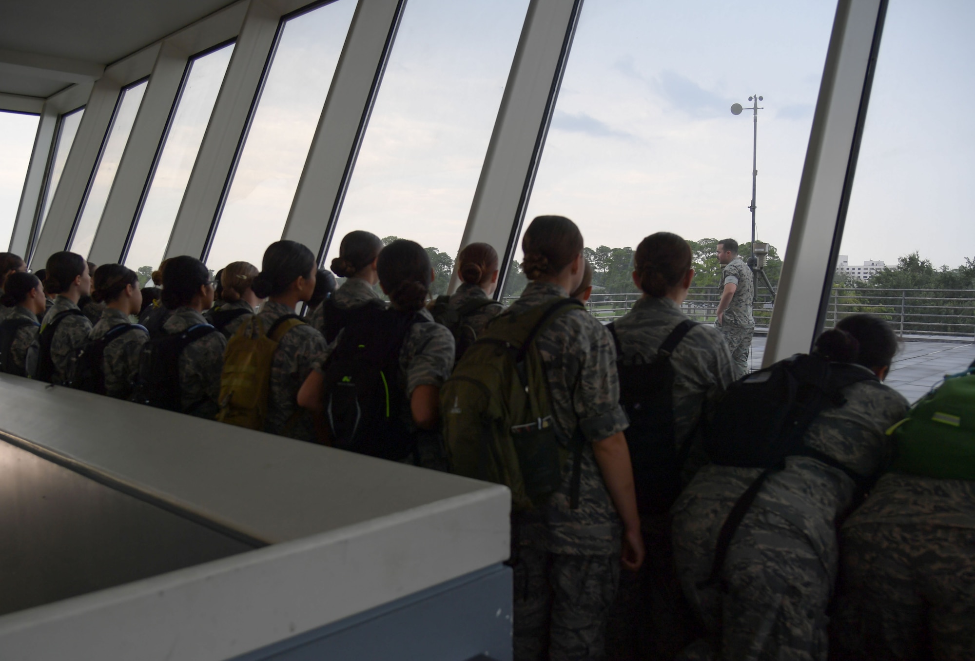 Cadets in military uniforms participate in activities on base.
