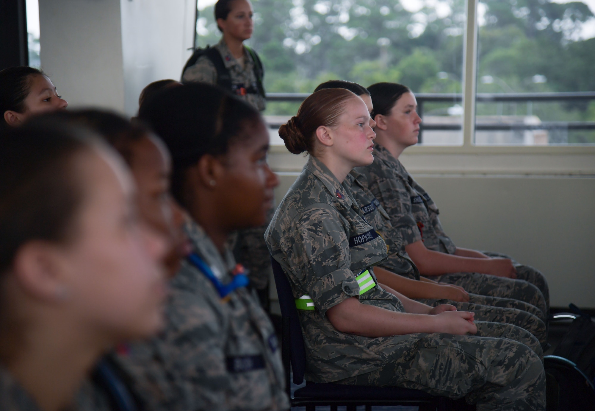 Cadets in military uniforms participate in activities on base.