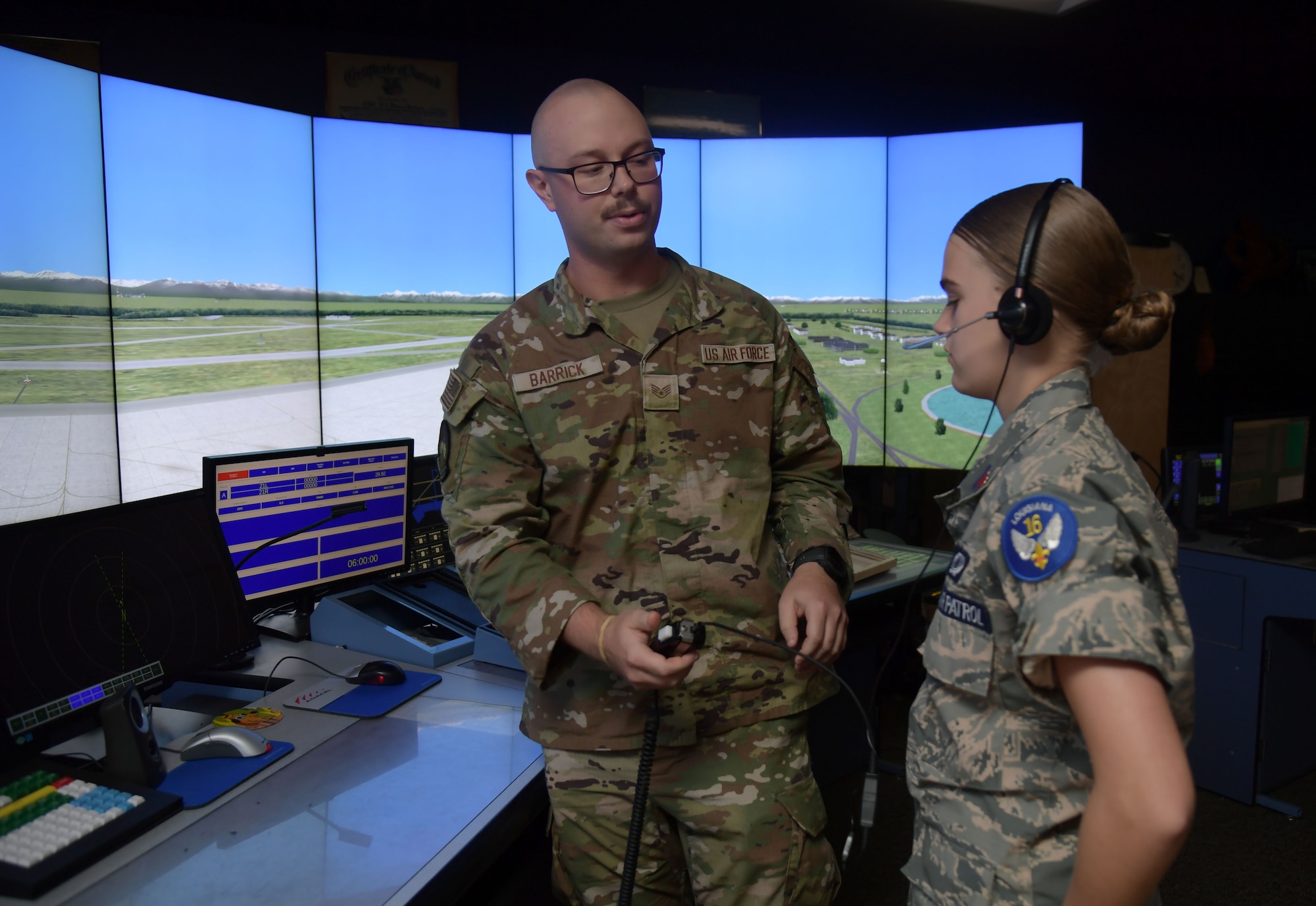 Cadets in military uniforms participate in activities on base.