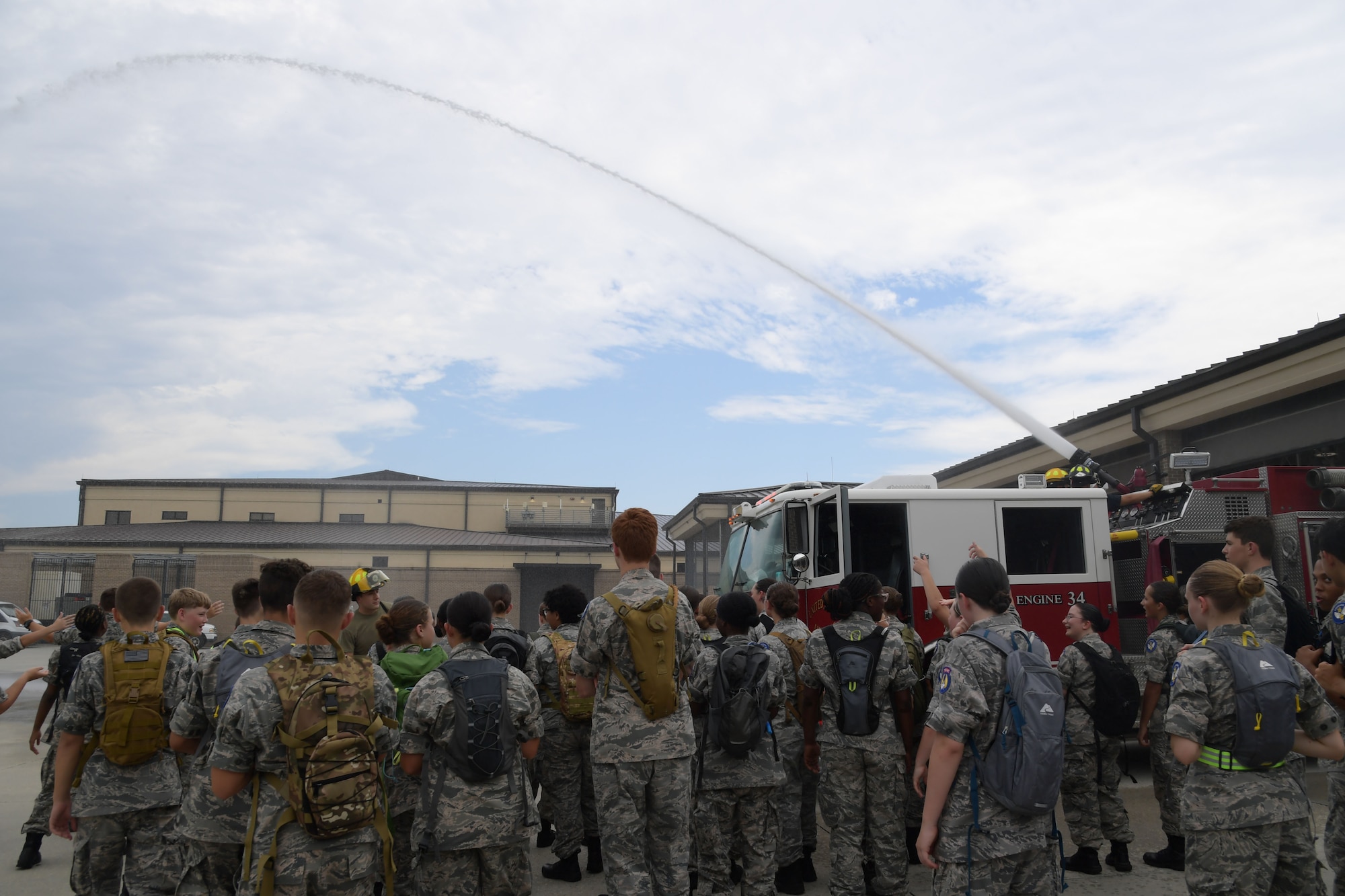 Cadets in military uniforms participate in activities on base.