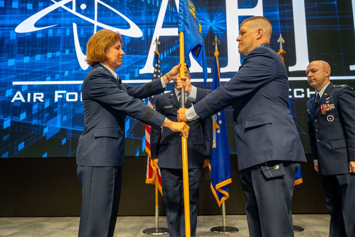 Air Force Institute of Technology alumnus, Lt. Col. James Bowers assumed command of Air University Detachment 1 at AFIT, Wright-Patterson Air Force Base, Ohio, during a recent ceremony.  Pictured is Commander and President of Air University, Lt. Gen. Andrea Tullos, left, incoming AU Detachment 1 Commander, Lt. Col. James Bowers, right, and outgoing AU Detachment 1 Commander, Col. Chris Rondeau, far right [AF contributed photo].