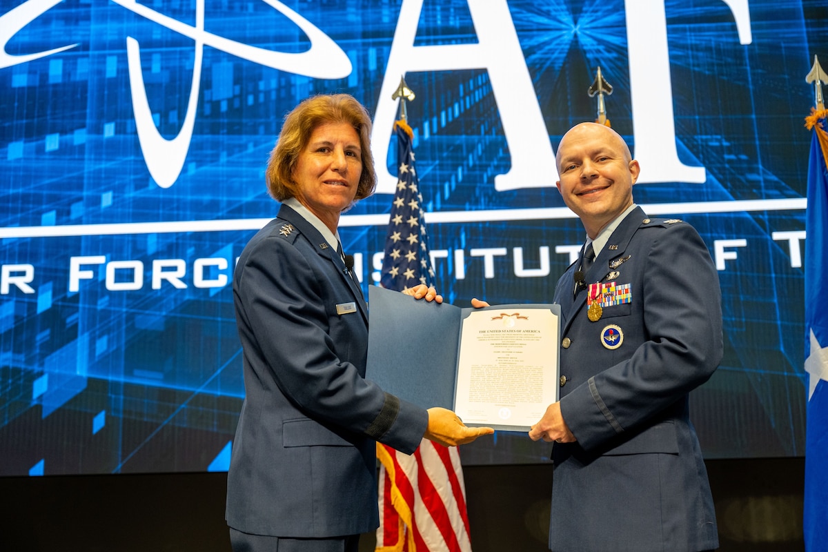 AFIT alumnus Lt. Col. James Bowers assumed command of Air University Detachment 1 at the Air Force Institute of Technology, Wright-Patterson Air Force Base, Ohio, during a recent ceremony.  Pictured is Commander and President of Air University, Lt. Gen. Andrea Tullos, left, and outgoing AU Detachment 1 Commander, Col. Chris Rondeau, right