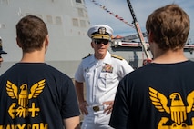 U.S. Navy Rear Adm Donald Wilson Marks, Commander of Carrier Strike Group Nine, Speaks with future Navy Sailors during an enlistment ceremony during Seattle Fleet Week , July 30, 2025. Seattle Fleet Week is a time-honored celebration of the sea services and provides an opportunity for the citizens of Washington to meet Sailors, Marines and Coast Guardsmen, as well as witness firsthand the latest capabilities of today's maritime services. (U.S. Marine Corps photo by Lance Cpl. Avery Wayland)