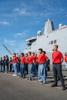 U.S. Marine Corps and Navy poolees stand in formation during a enlistment ceremony during Seattle Fleet Week in Seattle, July 30, 2025. Seattle Fleet Week is a time-honored celebration of the sea services and provides an opportunity for the citizens of Washington to meet Sailors, Marines and Coast Guardsmen, as well as witness firsthand the latest capabilities of today's maritime services. (U.S. Marine Corps photo by Lance Cpl. Avery Wayland)
