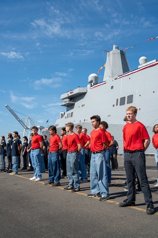 U.S. Marine Corps and Navy poolees stand in formation during a enlistment ceremony during Seattle Fleet Week in Seattle, July 30, 2025. Seattle Fleet Week is a time-honored celebration of the sea services and provides an opportunity for the citizens of Washington to meet Sailors, Marines and Coast Guardsmen, as well as witness firsthand the latest capabilities of today's maritime services. (U.S. Marine Corps photo by Lance Cpl. Avery Wayland)
