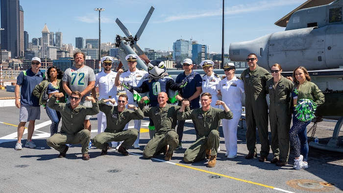 SEATTLE (July 30, 2025) – Sailors pose for a photo with Seattle Seahawks Dancers, Blitz and Seahawks Legend Joey Hollenbeck aboard the San Antonio-class amphibious transport dock ship USS Somerset (LPD 25) during Seattle Fleet Week, June 30, 2025. Seattle Fleet Week is a time-honored celebration of the sea services and provides an opportunity for the citizens of Washington to meet Sailors, Marines and Coast Guardsmen, as well as witness firsthand the latest capabilities of today’s maritime services. (U.S. Navy Photo by Mass Communication Specialist 2nd Class John A. Miller)