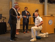 SEATTLE (July 30, 2025) – U.S. Navy Rear Adm. Wilson Marks, commander, Carrier Strike Group 9 (CSG 9), is knighted as Seafair Royalty at City Hall during Seattle Fleet Week, June 30, 2025. Seattle Fleet Week is a time-honored celebration of the sea services and provides an opportunity for the citizens of Washington to meet Sailors, Marines and Coast Guardsmen, as well as witness firsthand the latest capabilities of today’s maritime services. (U.S. Navy Photo by Mass Communication Specialist 2nd Class John A. Miller)