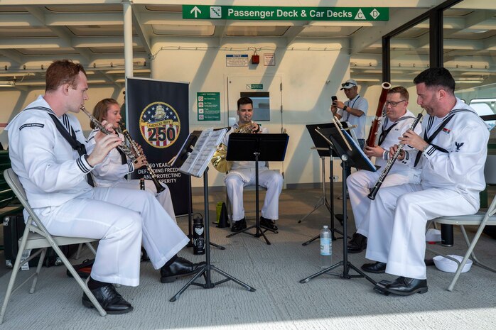 The Navy Band Northwest performs on the Seattle ferry during Seattle Fleet Week 2025. Seattle Fleet Week is a time-honored celebration of the sea services and provides an opportunity for the citizens of Washington to meet Sailors, Marines and Coast Guardsmen, as well as witness firsthand the latest capabilities. of today’s maritime services. (U.S. Navy photo by Mass Communication Specialist Seaman Joey Sitter)