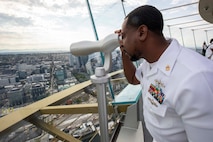 Chief Cryptologic Technician (Maintenance) Robert Phillips, from Ayden, N.C., looks out a viewing telescope on the observation deck of the Seattle Space Needle during Seattle Fleet Week 2025. Seattle Fleet Week is a time-honored celebration of the sea services and provides an opportunity for the citizens of Washington to meet Sailors, Marines and Coast Guardsmen, as well as witness firsthand the latest capabilities. of today’s maritime services. (U.S. Navy photo by Mass Communication Specialist Seaman Joey Sitter)