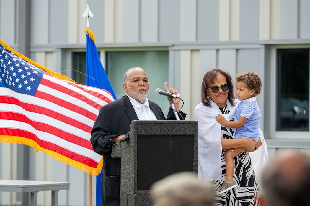 Stephan Ross Sr. and Angie Weaver speak about their father, Chief Elmer W. Ross, during a ceremony Aug. 2, 2025, at Wright-Patterson Air Force Base, Ohio. The event honored Chief Ross’s 23 years of civilian service and included the dedication of Fire Station 2 in his name.