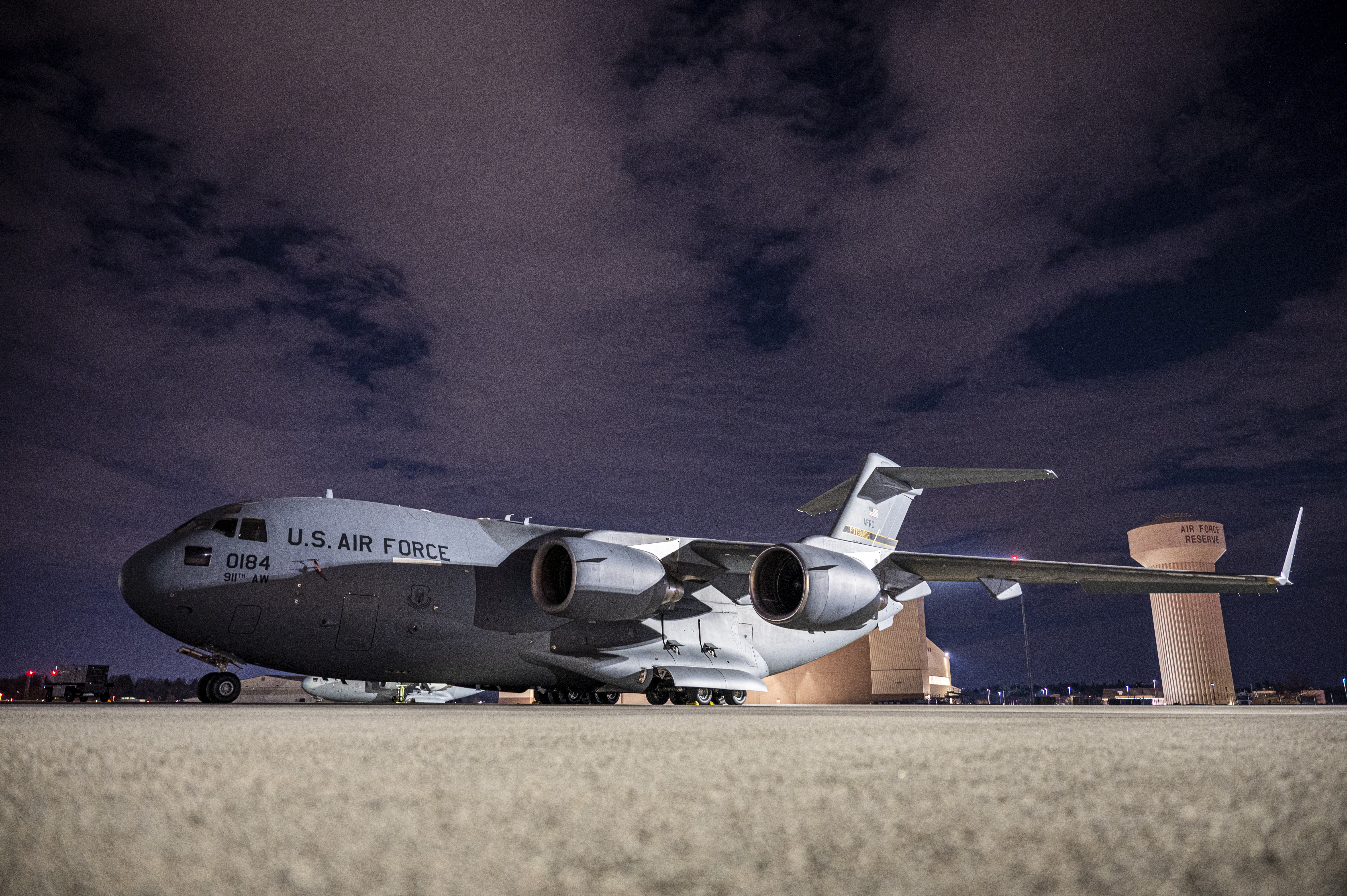 a c-17 globemaster 3 sites against the night sky