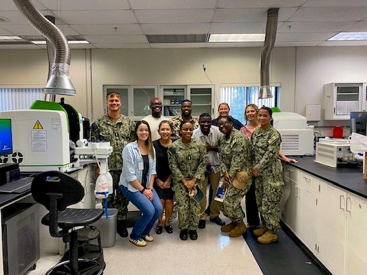 250718-O-NJ594-1203, San Diego, California, July 18, 2025 - Instructors and students of the Industrial Hygiene Techniques/Exposure Monitor Course (EMC) pose for a photo during a tour of the Certified Industrial Hygiene Laboratory within Navy Environmental Preventive Medicine Unit FIVE (NEPMU 5), in San Diego, California, July 17, 2025. The tour enhanced students’ understanding of laboratory analysis procedures, sampling media handling, environmental controls, and the role of laboratory support in occupational exposure assessments. The EMC course directly supports Navy Medicine’s commitment to improving the health and operational readiness of warfighters. (U.S. Navy courtesy photo by Chelsea Siepka)